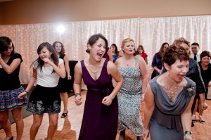 A wall of curtain lights behind the dance floor makes for beautiful wedding photos!